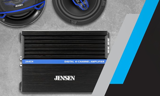 ja4ch 4 channel amplifier on table next to speakers