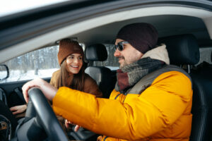 couple driving in car enjoying music